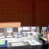 Student stands by Dutton Christian's Monarch Waystation